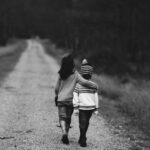 grayscale photography of kids walking on road
