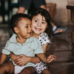 selective focus photography of girl hugging boy