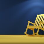 a wooden rocking chair sitting on top of a yellow floor